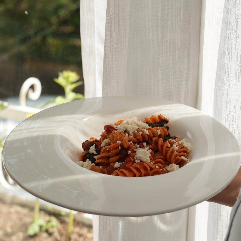 Fusilli alla Norma with aubergine and aged ricotta, carried to the table