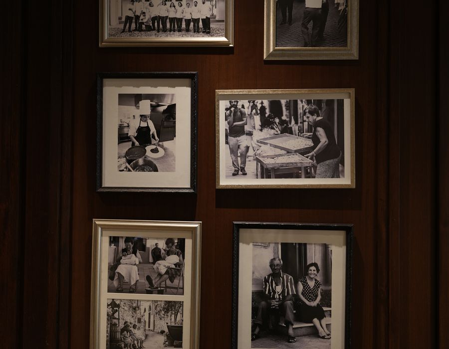 Framed archive portraits arranged across a panelled door