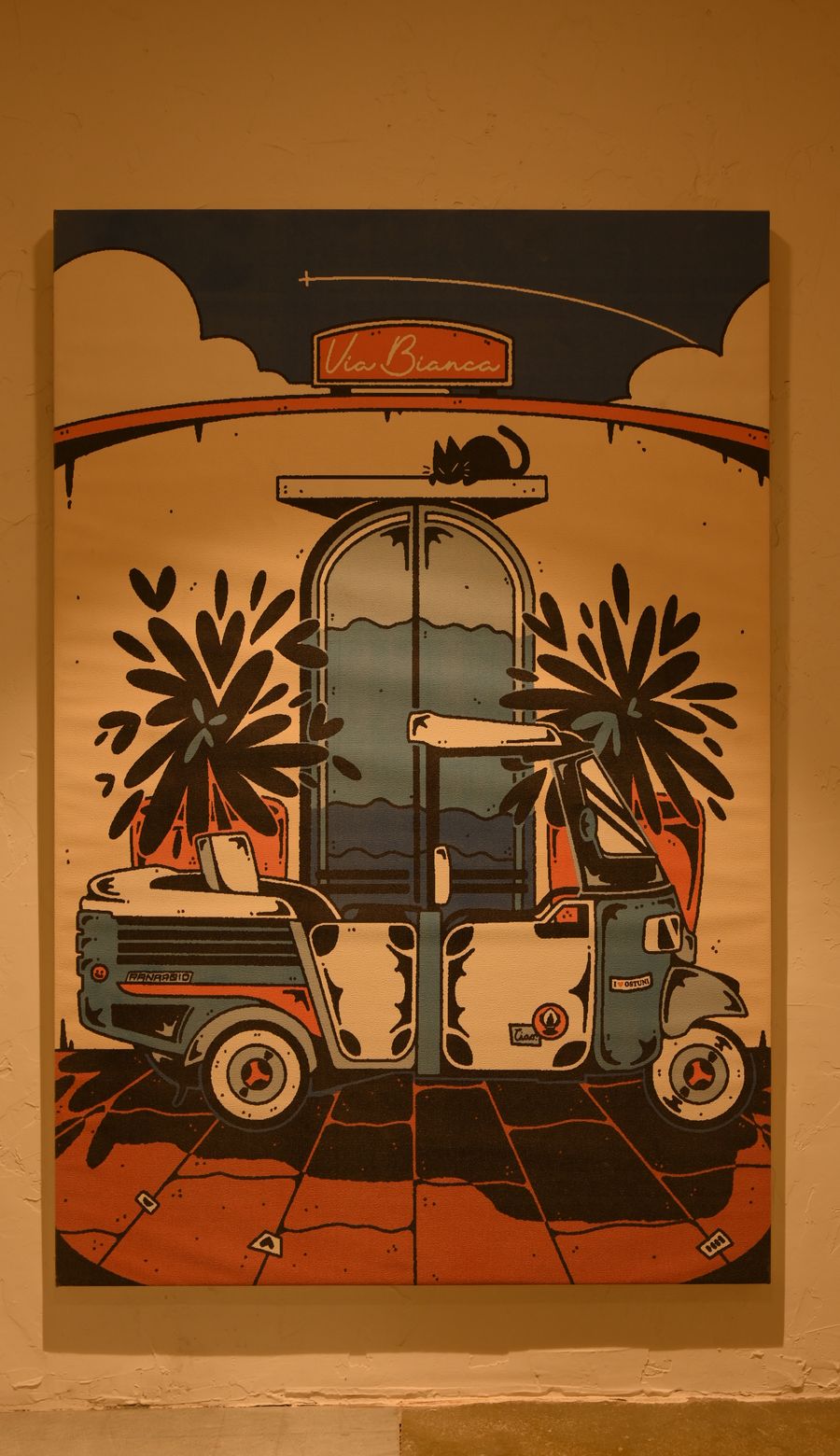 A painted mural of a Vespa beneath an archway